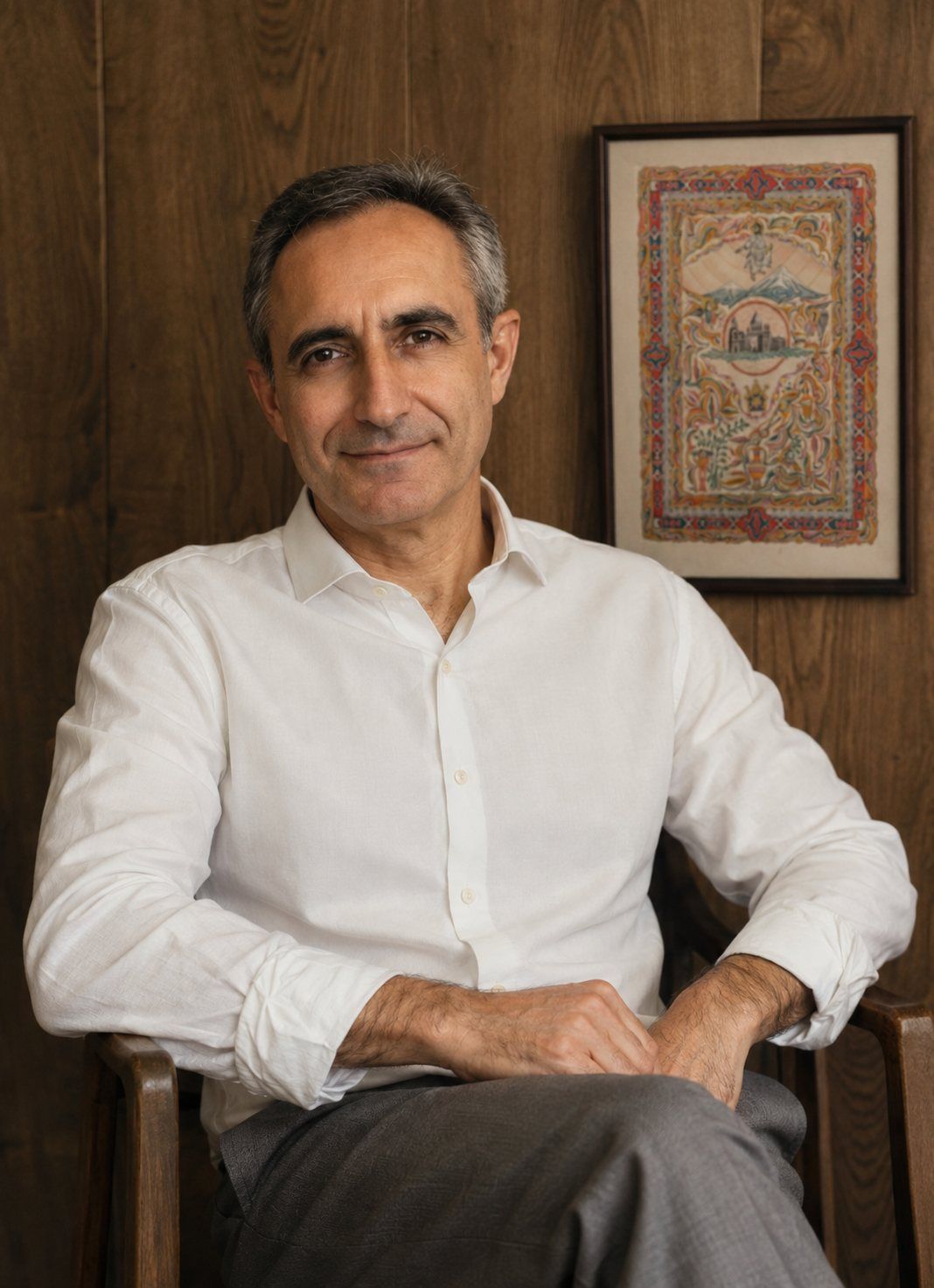 Armen Daneghyan seated beside one of his miniatures